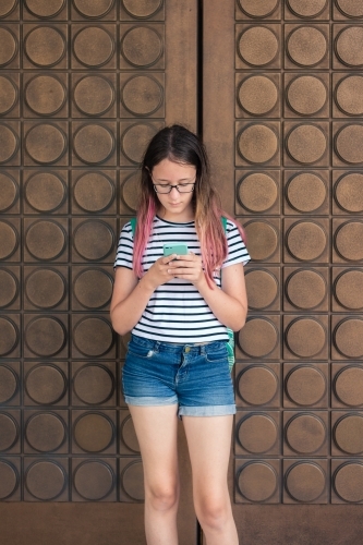 teen girl texting on phone - Australian Stock Image