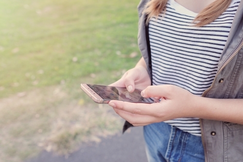 Teen girl using mobile phone - Australian Stock Image