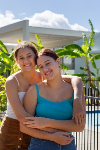 teen girls with arms around each other - Australian Stock Image
