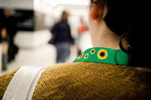 Teen with disability wearing a sunflower lanyard at an airport - Australian Stock Image
