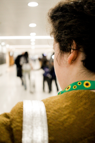 Teen with disability wearing a sunflower lanyard at an airport - Australian Stock Image