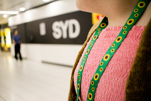 Teen with disability wearing a sunflower lanyard at an airport - Australian Stock Image
