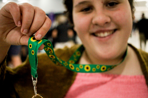 Teen with disability wearing a sunflower lanyard at an airport - Australian Stock Image