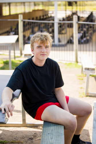 Teenage boy hanging out at outdoor go-kart track - Australian Stock Image