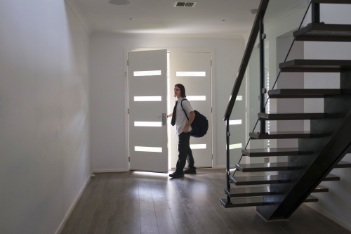 Teenage boy in school uniform leaves home - Australian Stock Image