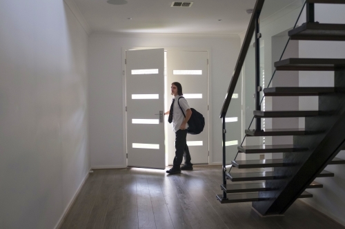 Teenage boy in school uniform leaves home