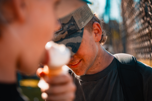 Teenage boys with dirty faces from soot watching burnout competition - Australian Stock Image
