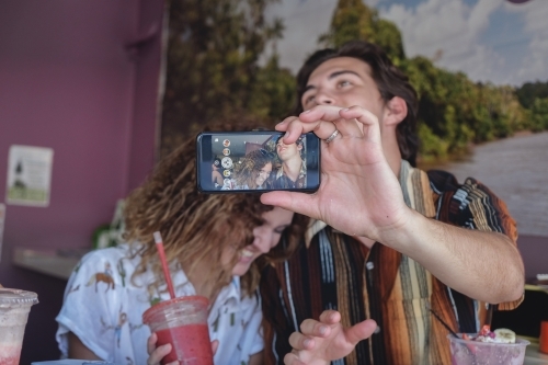 Teenage couple taking selfie