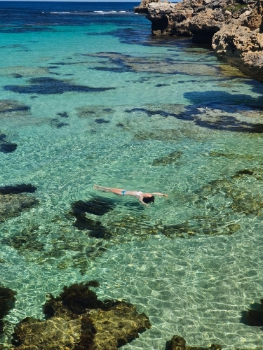 Teenage girl floating in the ocean - Australian Stock Image
