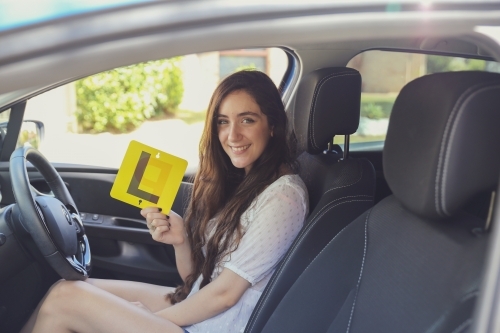 Teenage girl holding L plate - Australian Stock Image