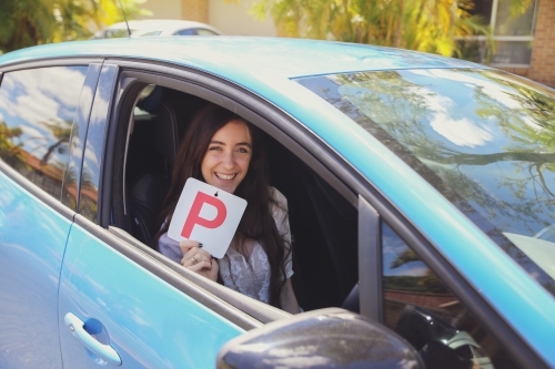 Teenage girl holding P plate - Australian Stock Image