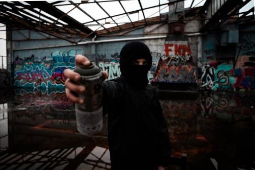 Teenage vandal with spray paint in his hand