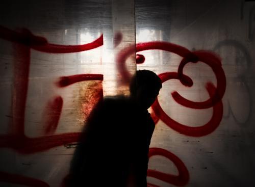 Teenager silhouette peaking from behind plastic sheeted doors