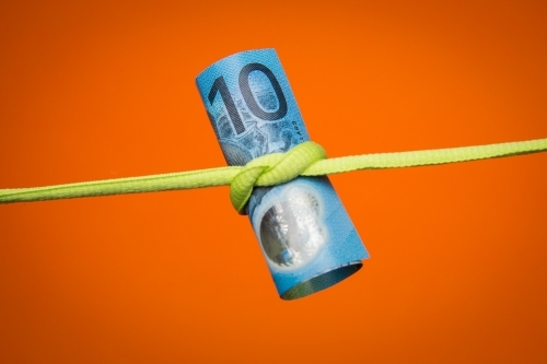 Ten Dollars Tied Up on an Orange Background - Australian Stock Image