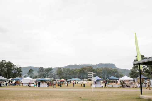 Tent stalls set up in public park for festival event - Australian Stock Image