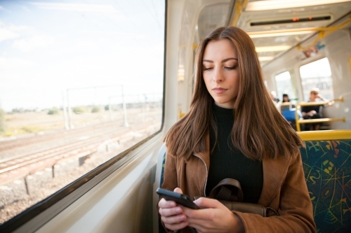 Texting on the Train - Australian Stock Image