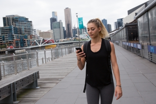 Texting While Walking Through Southbank - Australian Stock Image