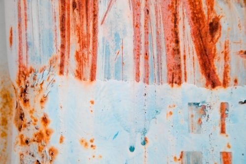 Textures and patterns on the side of a shipping container with rust and peeling paint - Australian Stock Image