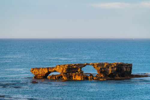 The Doorway Rock in Robe during sunrise, Cape Dombey, Limestone Coast, South Australia - Australian Stock Image