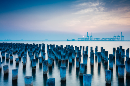 The historic Princes Pier featuring many disused pylons on a hot summer's day - Australian Stock Image