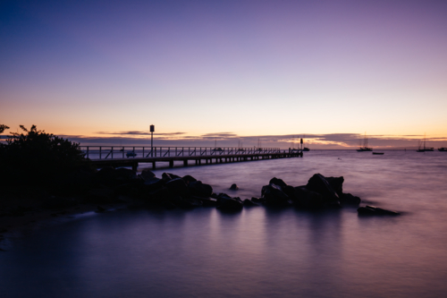 The iconic Cameron's Bight Jetty on a cool winter's morning at sunrise on the Mornington Peninsula - Australian Stock Image