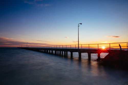 The iconic Rye Pier on a cool winter's morning at sunrise on the Mornington Peninsula in Melbourne, - Australian Stock Image