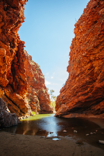 The iconic Simpsons Gap and its orange rock formations in MacDonnell Ranges National Park - Australian Stock Image