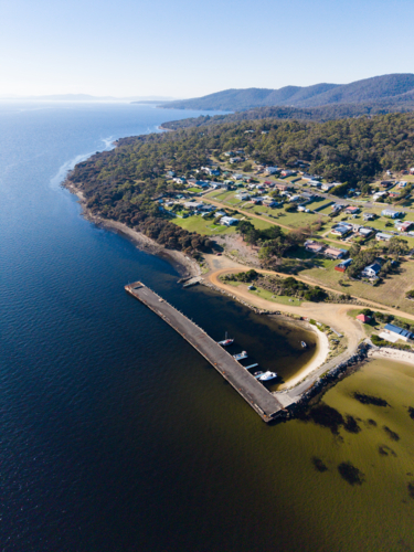 The jetty area along the beach in front of Allonnah, Bruny Island - Australian Stock Image