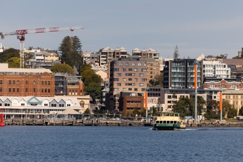 The Newcastle-Stockton ferry crossing the Hunter River with view of Newcastle city in background - Australian Stock Image