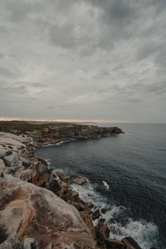 The rocky cliffs of Magic Point on the coastal walk at sunset.
