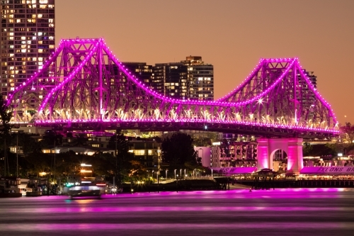 The Story Bridge illuminated magenta/pink after the sun has set - Australian Stock Image