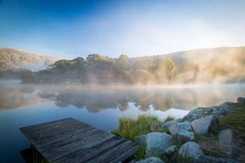 The sun rises over Lake Crackenback on a cold autumn morning in New South Wales, Australia - Australian Stock Image