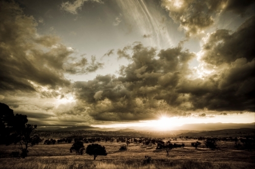 The sun sets over the Brindabella Range, west of Canberra - Australian Stock Image