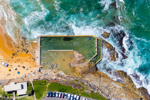The tidal rockpool at the southern end of Curl Beach. - Australian Stock Image