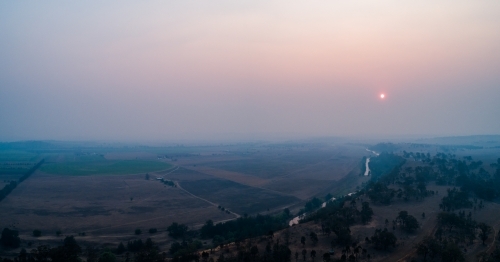 Thick smoke haze over farmland in hunter valley from bushfires - Australian Stock Image