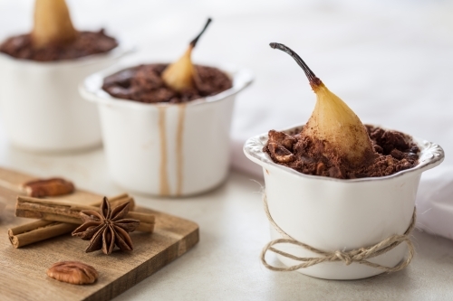 Three Baked Chocolate Pear Dessert in ramekins - Australian Stock Image