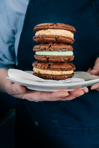 Three delicious biscuits stacked on a plate.