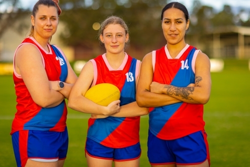 Three female football players standing with arms crossed - Australian Stock Image