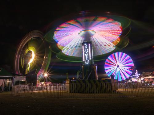 Three festival night time amusement rides - Australian Stock Image