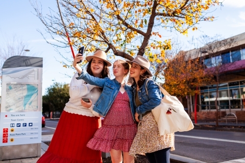 Three girls take a selfie in urban area of small country town in Australia - Australian Stock Image
