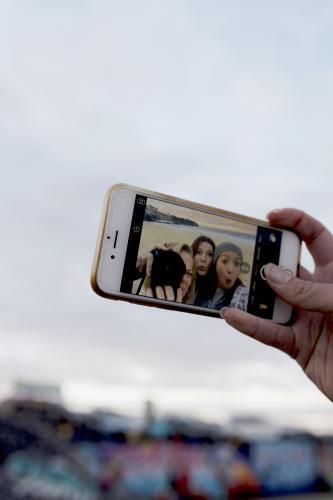 Three girls taking a selfie on their iphone - Australian Stock Image