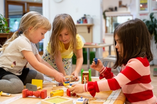 Three little girls playing at pre-school - Australian Stock Image