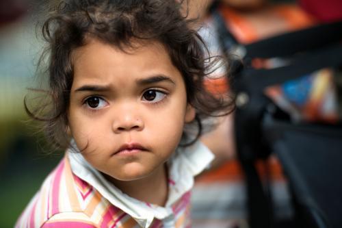 Three year old Aboriginal Girl Holding Pusher - Australian Stock Image