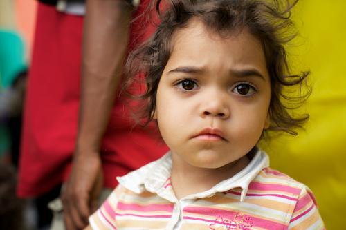 Three Year Old Aboriginal Girl on Yellow and Red Background - Australian Stock Image