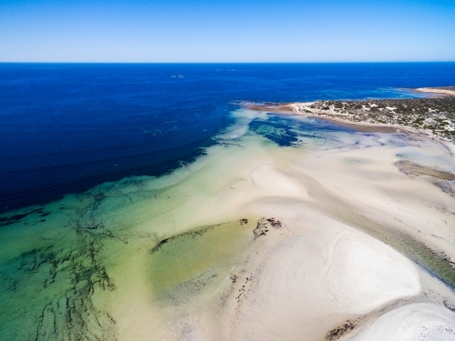 Tidal flats with creek running out to sea - Australian Stock Image