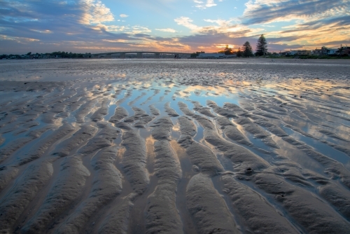 Tidal sand flat at sunset with sand ripples - Australian Stock Image