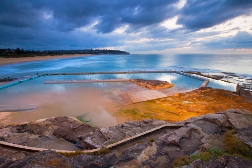 Tidal swimming baths in soft predawn lighting - Australian Stock Image