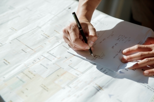 Working with plans and architectural drawings for renovation - Australian Stock Image