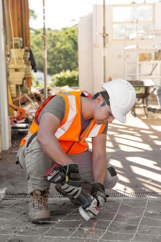 Tiler working on cement tiles and paving - Australian Stock Image