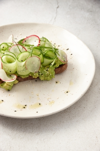 Toast with thin sliced cucumbers and scallions on top